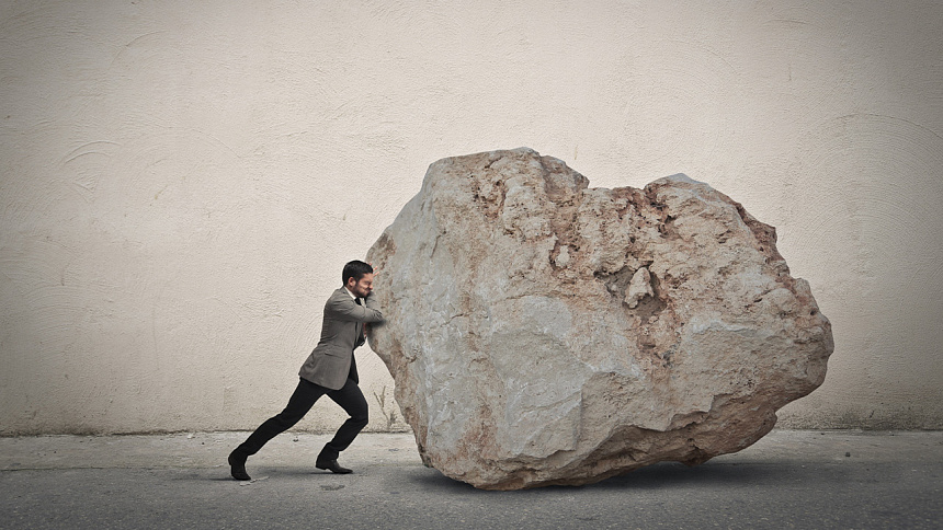 мужчина толкает камень фото